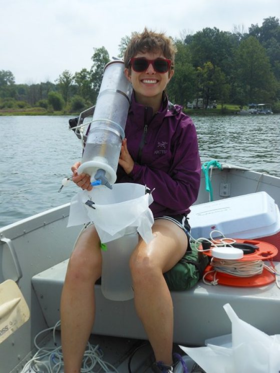 Marian Schmidt sampling water on Bristol Lake near Battle Creek, Mich. to see how bacterial community composition varies with lake productivity levels.