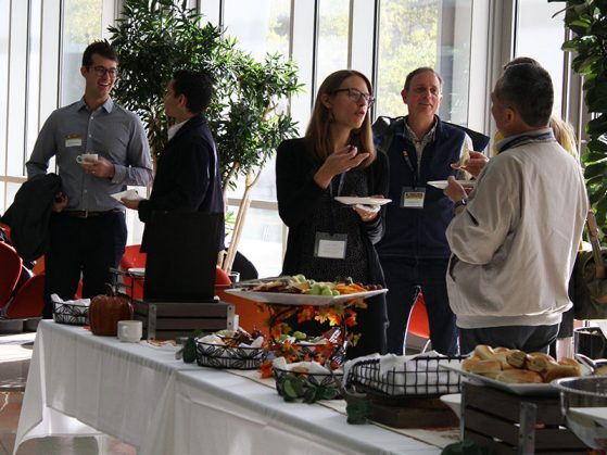 Symposium attendees and speakers share ideas during the morning break. 