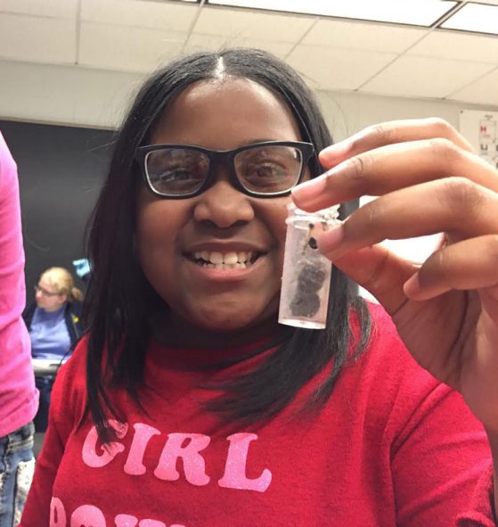 A happy student shows off a discovery. 