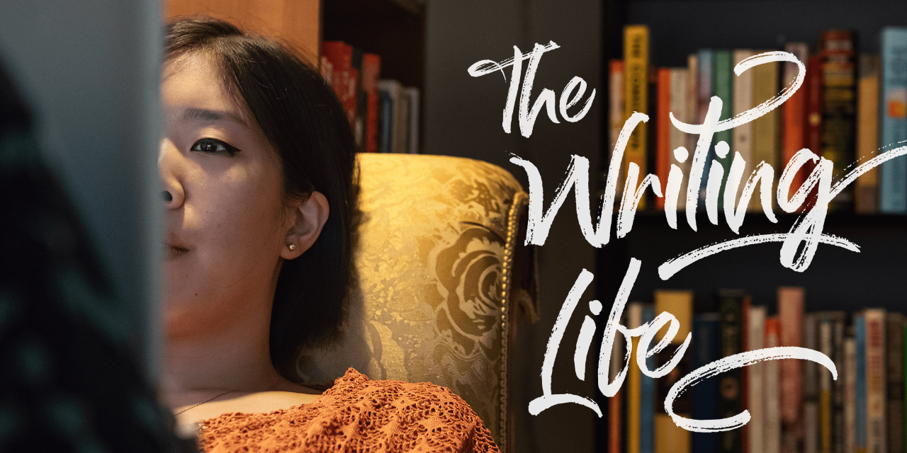 A close-up photograph of Lillian Li, a woman with dark hair reclining on a couch upholstered in gold fabric, immersed in the act of reading.
